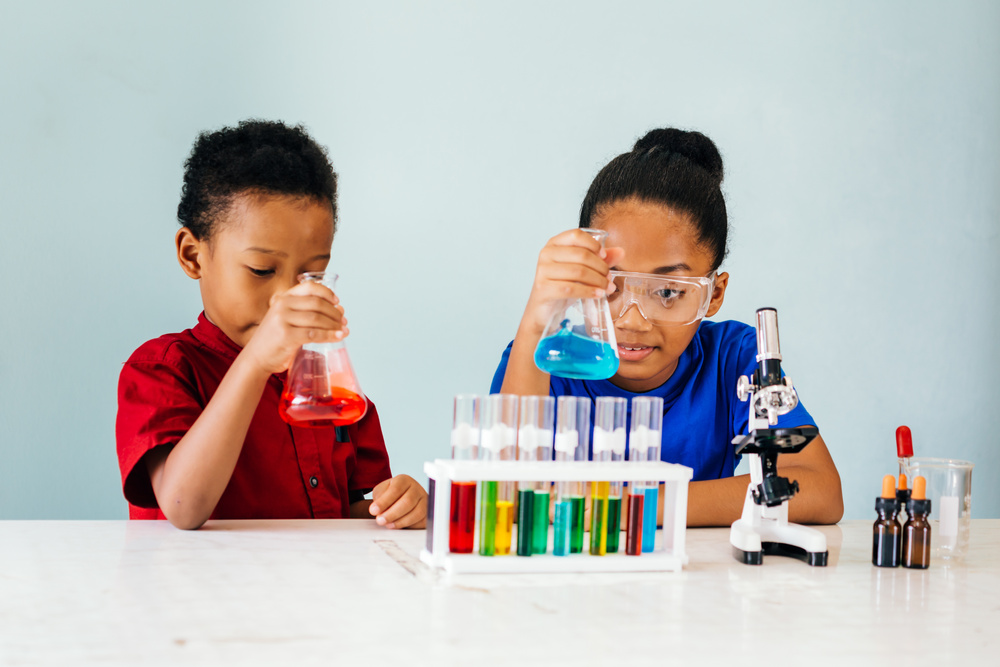 Curious Black Children Experimenting in School Chemistry Laborat