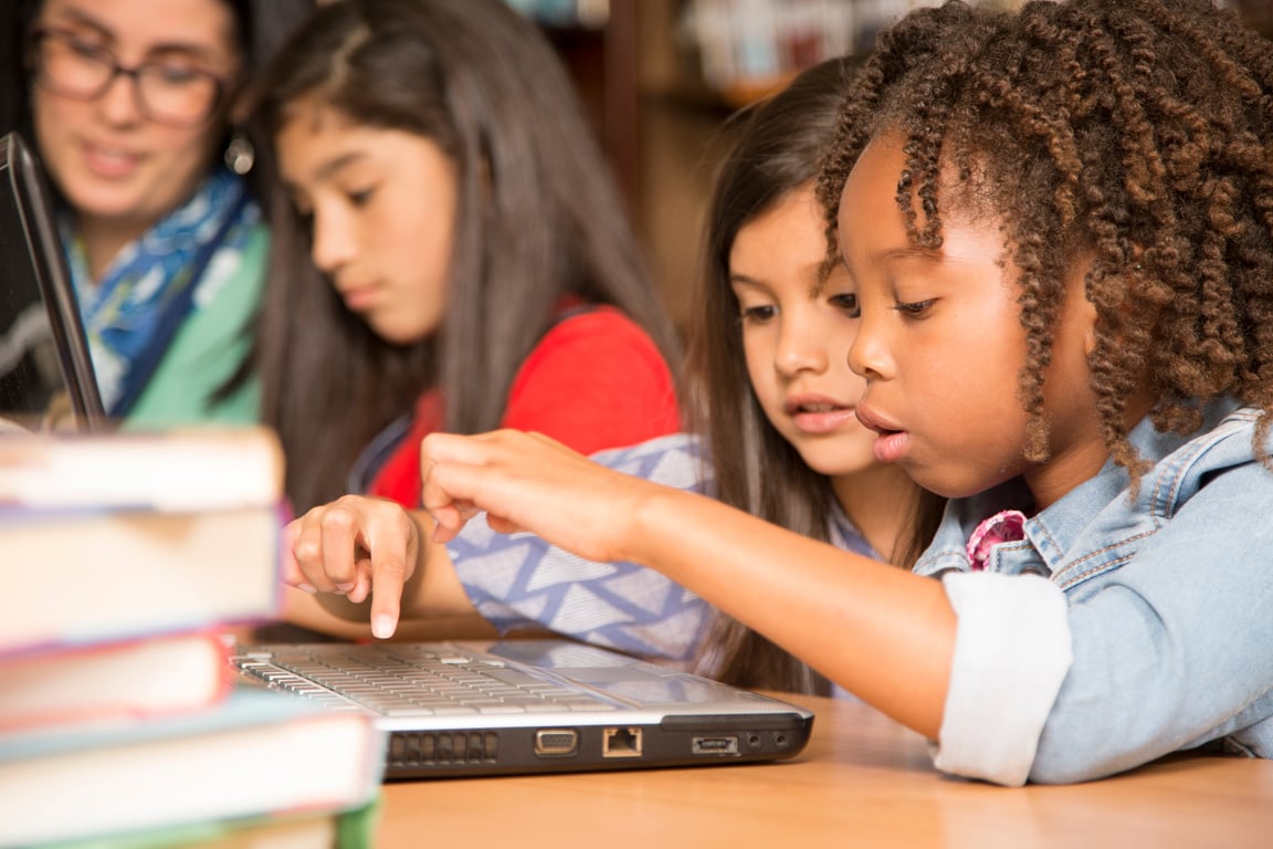 Elementary-age children learn computer coding in school.